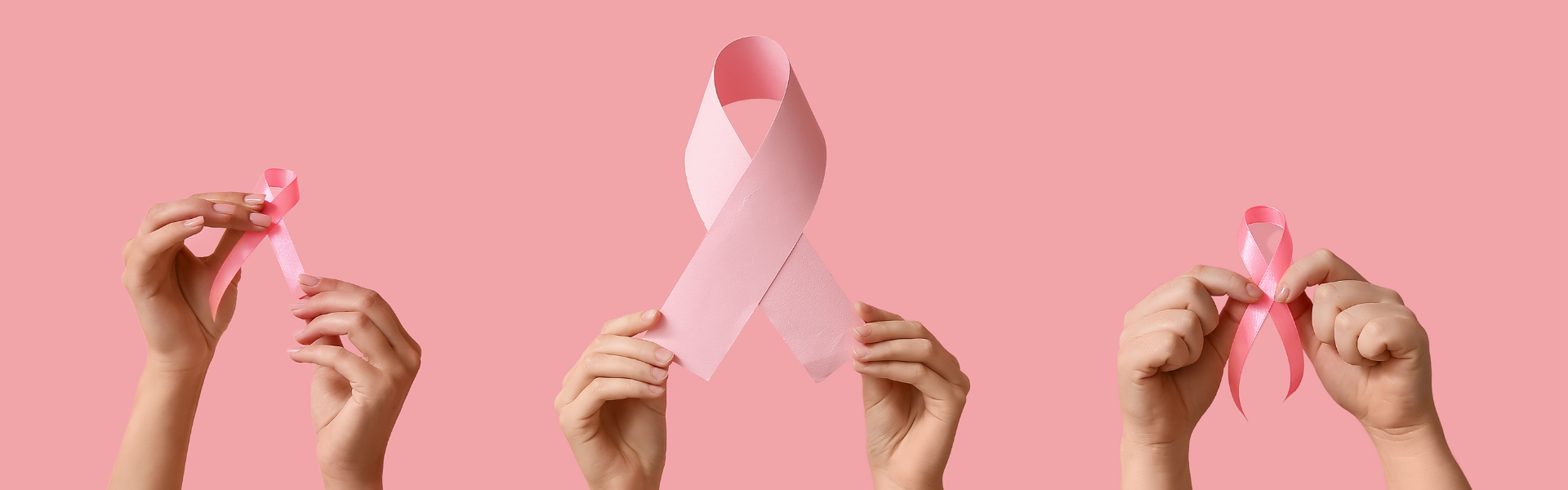 Image of three sets of hands holding pink ribbons on a pink background
